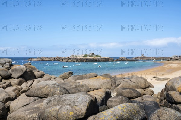 The wide bay of Tregastel on the Cote de Granit Rose shows the turquoise blue sea with white