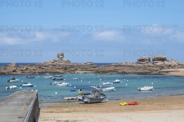 On the harbour beach of Tregastel on the Cote de Granit Rose, small sailing boats are moored next