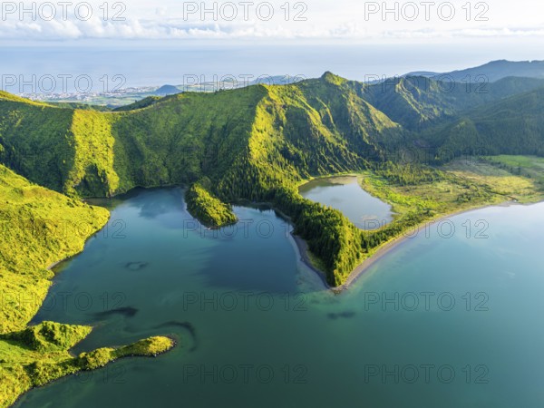 Lagoa do Fogo Lake on Sunny Morning. Green Lush Hills, Mountains and Atlantic Ocean. Azores, Sao