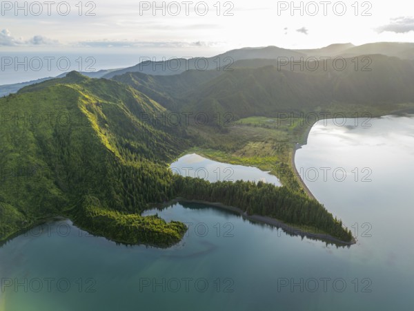 Lagoa do Fogo Lake on Sunny Morning. Green Lush Hills with Forest and Mountains. Azores, Sao Miguel