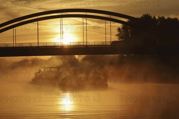 Ship on the Datteln-Hamm Canal in the morning fog at sunrise, Bergkamen, North Rhine-Westphalia,