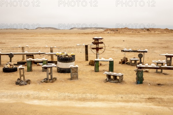 Pink salt displayed on wooden stands along the road to Namib-Naukluft National Park and Sandwich
