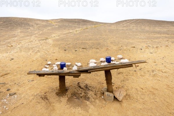 Pink salt displayed on wooden stands along the road to Namib-Naukluft National Park and Sandwich