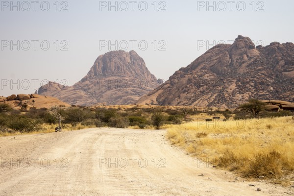 Granite peaks and rugged desert landscape at Spitzkoppe Community Campsite, Namibia. Golden