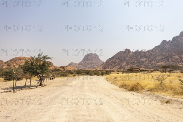 Granite peaks and rugged desert landscape at Spitzkoppe Community Campsite, Namibia. Golden