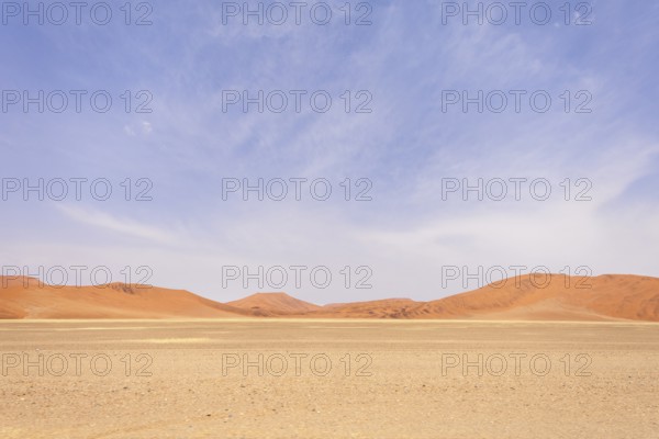 Sossusvlei in Namibia is a desert wonder, famous for its giant red dunes, glowing at sunrise and