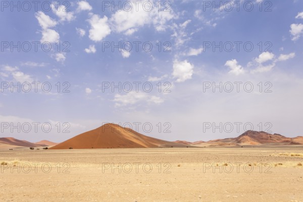 Sossusvlei in Namibia is a desert wonder, famous for its giant red dunes, glowing at sunrise and