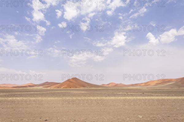 Sossusvlei in Namibia is a desert wonder, famous for its giant red dunes, glowing at sunrise and