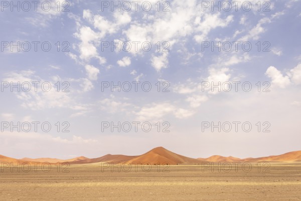 Sossusvlei in Namibia is a desert wonder, famous for its giant red dunes, glowing at sunrise and