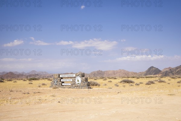 Stone entrance sign of Namib-Naukluft National Park in Namibia- 27 August, 2025: surrounded by