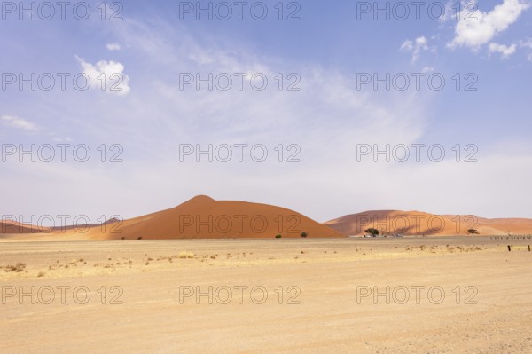 Sossusvlei in Namibia is a desert wonder, famous for its giant red dunes, glowing at sunrise and