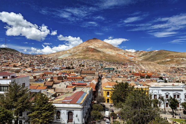 Lively city in front of a high mountain under an expressionist sky, the Cerro Rico silver mountain