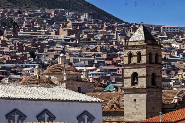 Historic cityscape with towers and densely built-up areas under a blue sky, view over the city of