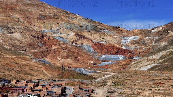 Reddish mountain landscape with visible mines under a clear sky, the Cerro Rico silver mountain in