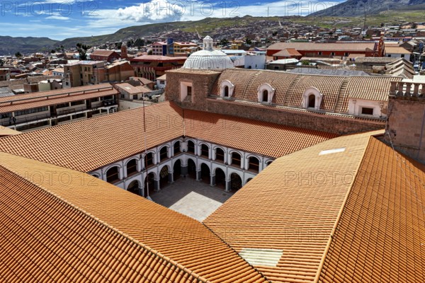 Architectural courtyard of a monastery with tiled roofs in a city, view over the city of Potosi in
