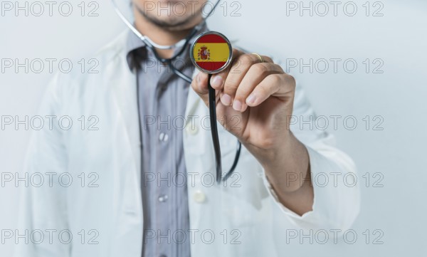 Spain national healthcare. Doctor showing stethoscope with Spain flag