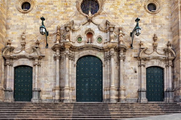 Monumental façade with three green double doors and complex decorations, impressive symmetry, The