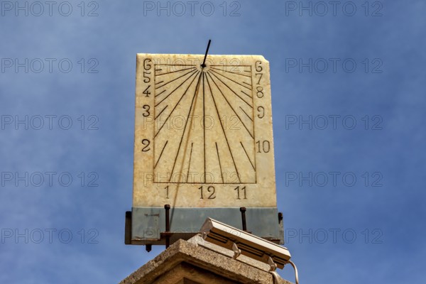 Classic stone sundial with clear dial and hands against a sunny background, The sundial of Potosi