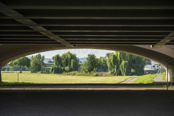 View under a bridge onto a summer landscape with willow trees, Minden waterway junction,
