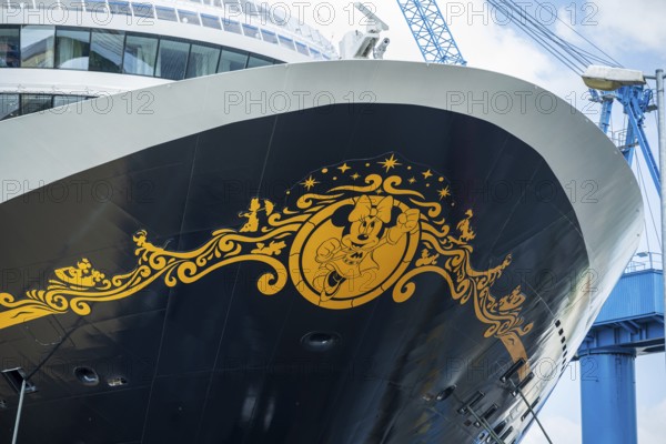 Detailed view of the decorated bow of a cruise ship with a crane in the background, cruise ship in