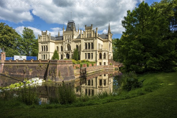 Gothic castle in perspective with moat surrounded by green landscape, Evenburg Castle, Leer, East