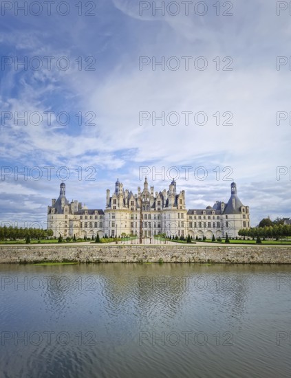 The symmetrical Château de Chambord is reflected in the still water, highlighting its magnificent