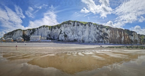Panoramic view of Dieppe beach in Normandy, France. Majestic white chalk cliffs rise above a pebble