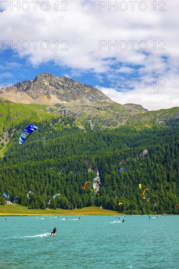 Kitesurfing on Alpine Lake Silvaplana in a Sunny Summer Day with Mountain View in the Swiss Alps in