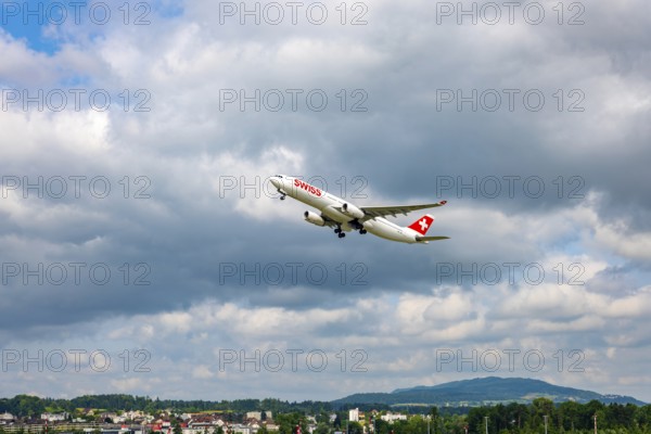 Swiss Airlines Passenger Airplane Take Off From the Runway and Flying Against Blue Sky and Clouds