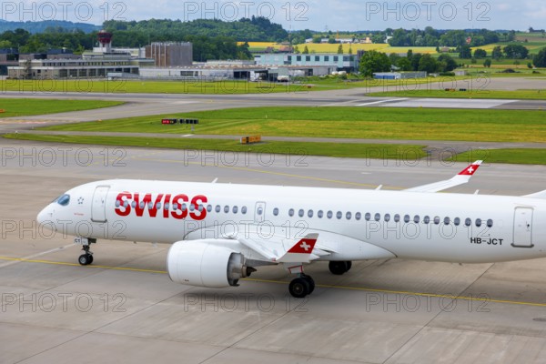 Swiss Airlines Passenger Airplane Taxiing on Runway in a Sunny Summer Day From the Airport in