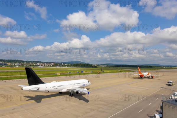 SAS and Easyjet Airlines Passenger Airplane Taxiing and Take Off on Runway in a Sunny Summer Day
