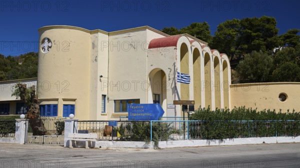 Primary school, Modern yellow building with arched entrances and Greek flag, Historicism, Art Deco,