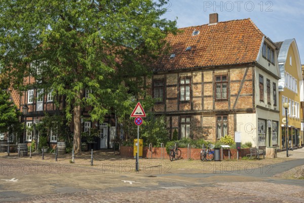 Half-timbered building with red bricks on a quiet street. Bicycles are also available, Verden an
