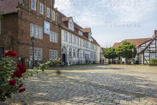 Historic half-timbered houses with cobbled square and roses. Quiet and peaceful atmosphere, Verden