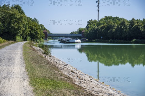 Canal with riverside path and bridge. Natural scenery with a summer atmosphere, Dortmund-Ems Canal
