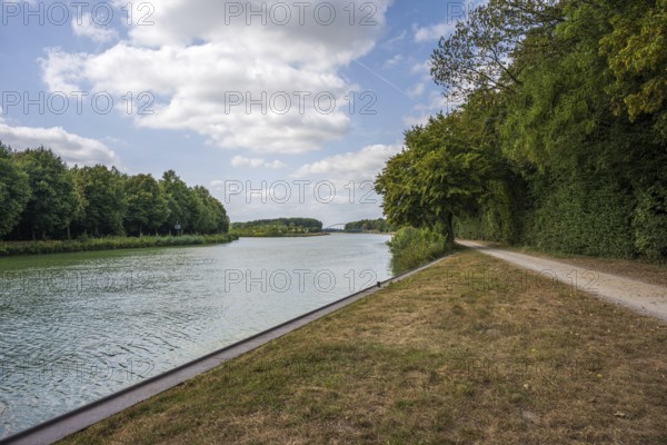 Idyllic river with adjoining path, framed by trees under a partly cloudy sky, Senden, Münsterland,