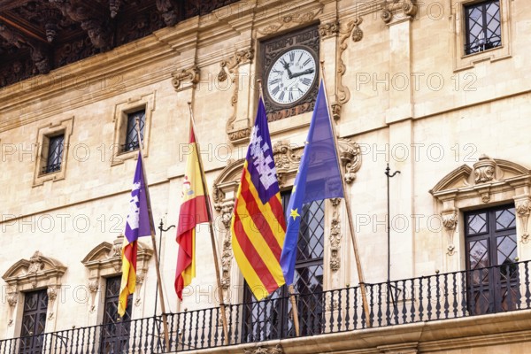 Spanish and Mallorcan flags with the EU flag on the balcony at city hall in Palma, Palma de
