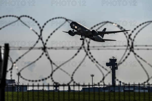 Symbolic image security at the airport, outer fence at Düsseldorf International Airport, steel wire