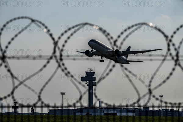 Symbolic image security at the airport, outer fence at Düsseldorf International Airport, steel wire
