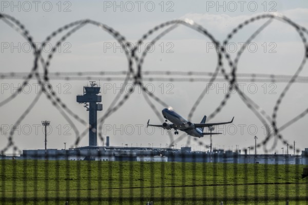 Symbolic image security at the airport, outer fence at Düsseldorf International Airport, steel wire