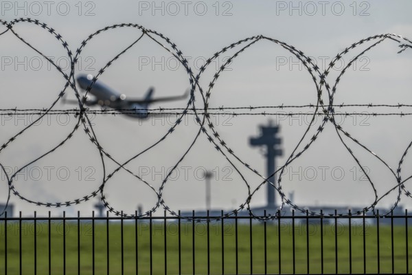 Symbolic image security at the airport, outer fence at Düsseldorf International Airport, steel wire