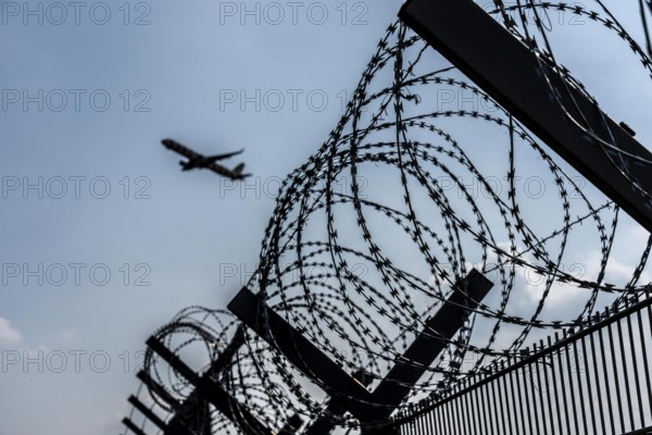 Symbolic image security at the airport, outer fence at Düsseldorf International Airport, steel wire