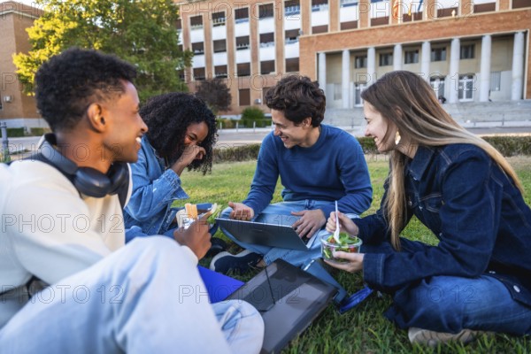 Group of diverse university students enjoying a refreshing outdoor lunch together on a grassy