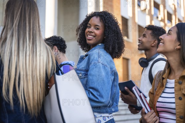 Group of multi ethnic university students walking together on campus, smiling, and looking around,