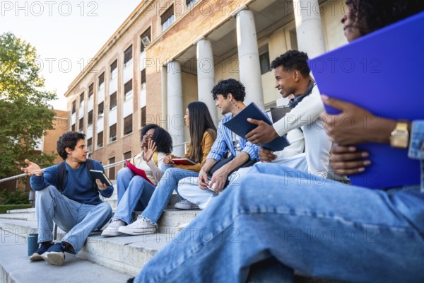 Group of diverse university students sitting on campus steps, discussing and sharing ideas in an