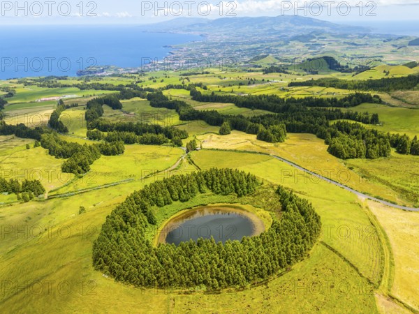 Lake Pau Pique and Lush Green Hills with Pasturelands on Sunny Day. Atlantic Ocean. Azores, Sao
