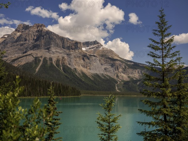 Emerald Lake with lush greenery and the rugged Canadian Rocky Mountains within Yoho National Park