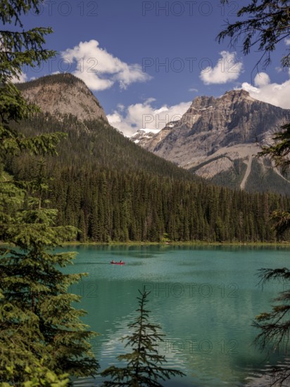 Kayak on Emerald Lake encircled by the Canadian Rocky Mountains and forest within Yoho National
