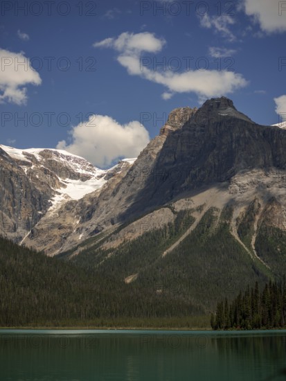 Towers of snowy peaks of the Canadian Rocky Mountains next to Emerald Lake inside Yoho National