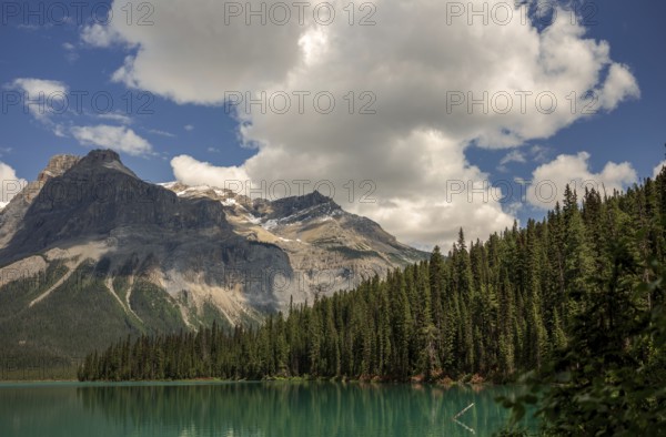 The Canadian Rocky Mountains with clouds above Emerald and dense forest inside Yoho National Park,